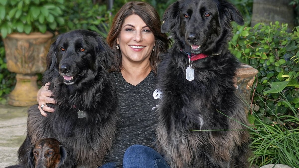 A photo of Robin Bertolucci and her 3 dogs.