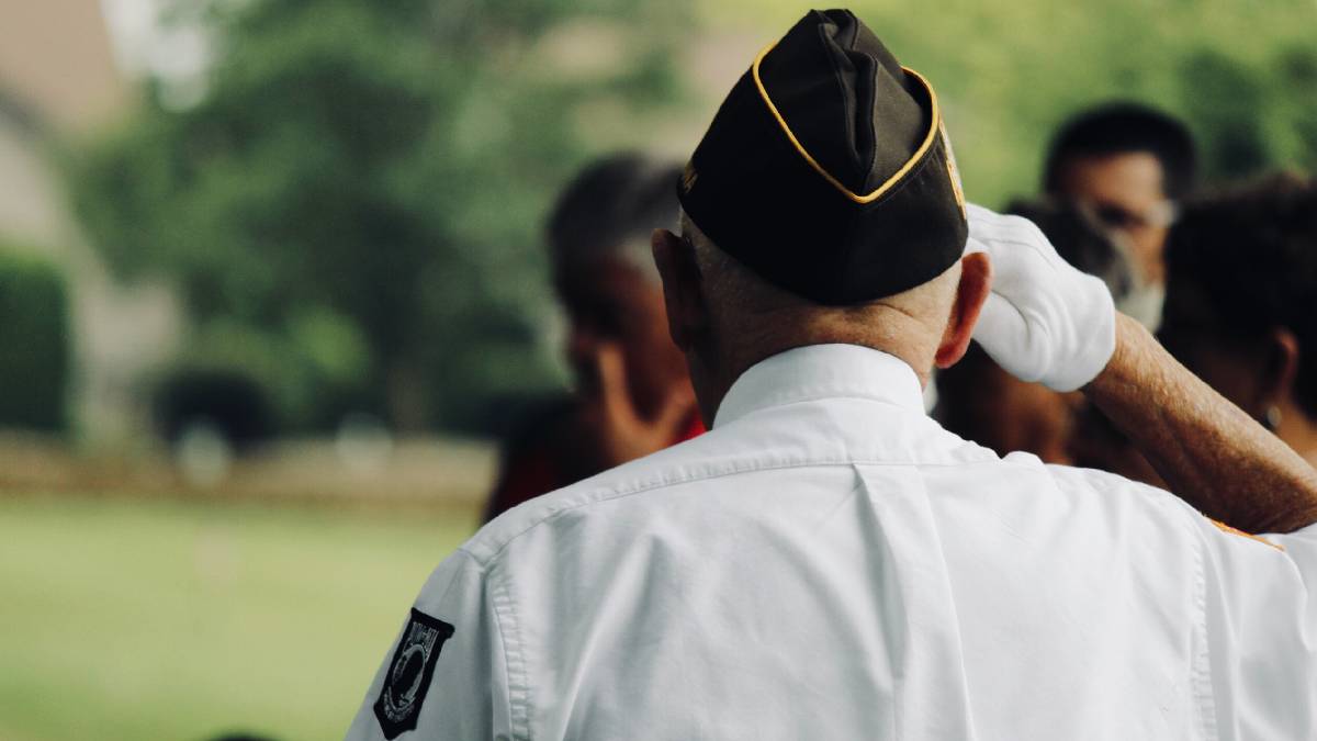 A photo of a veteran saluting the American flag