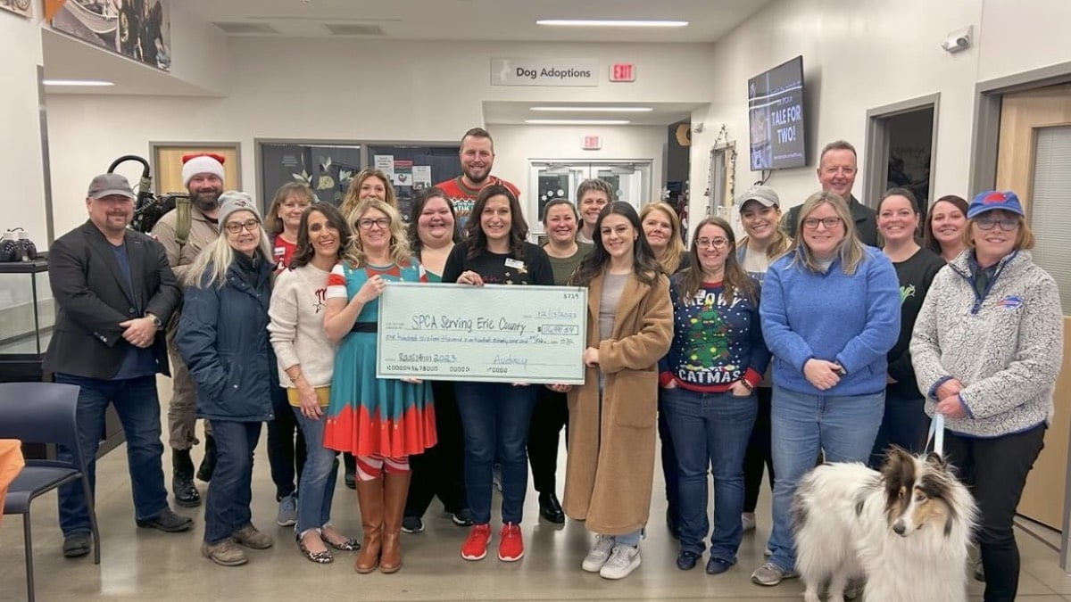 A photo of the Audacy Buffalo staff presenting a check