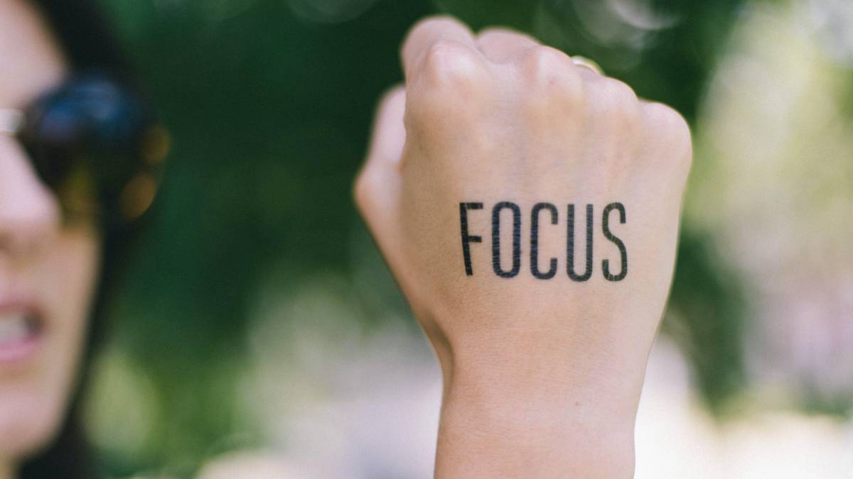 A photo of the word focus written on a hand