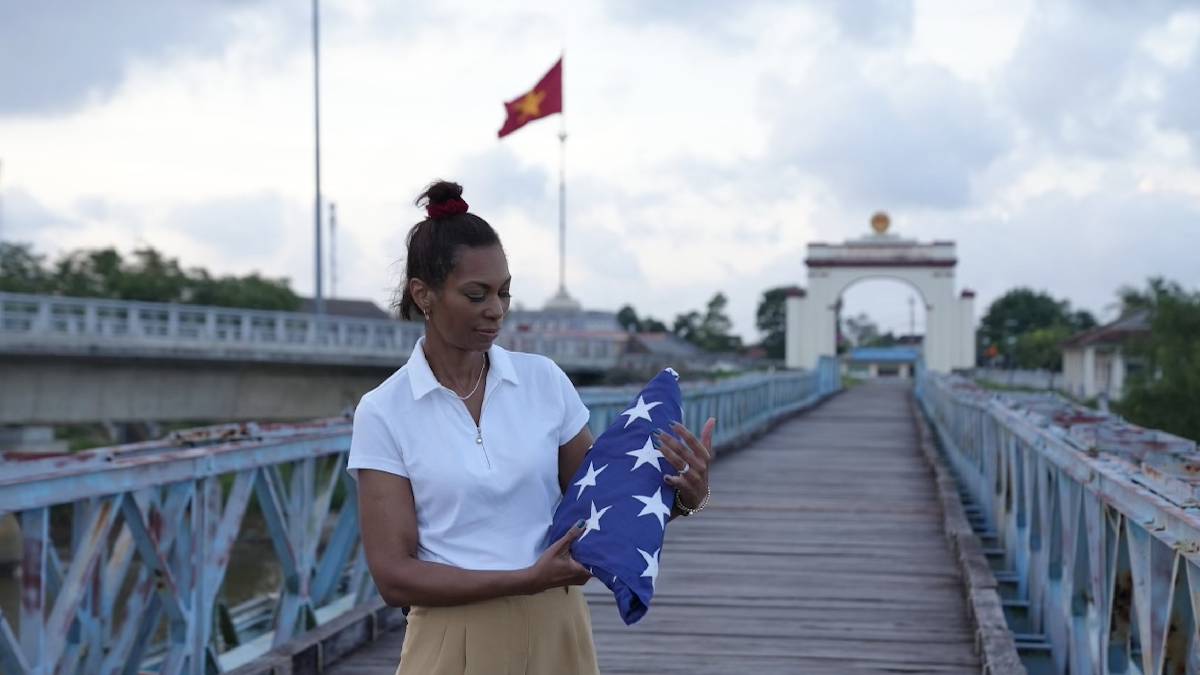 A photo of Harris Faulkner accepting an American flag in Vietnam