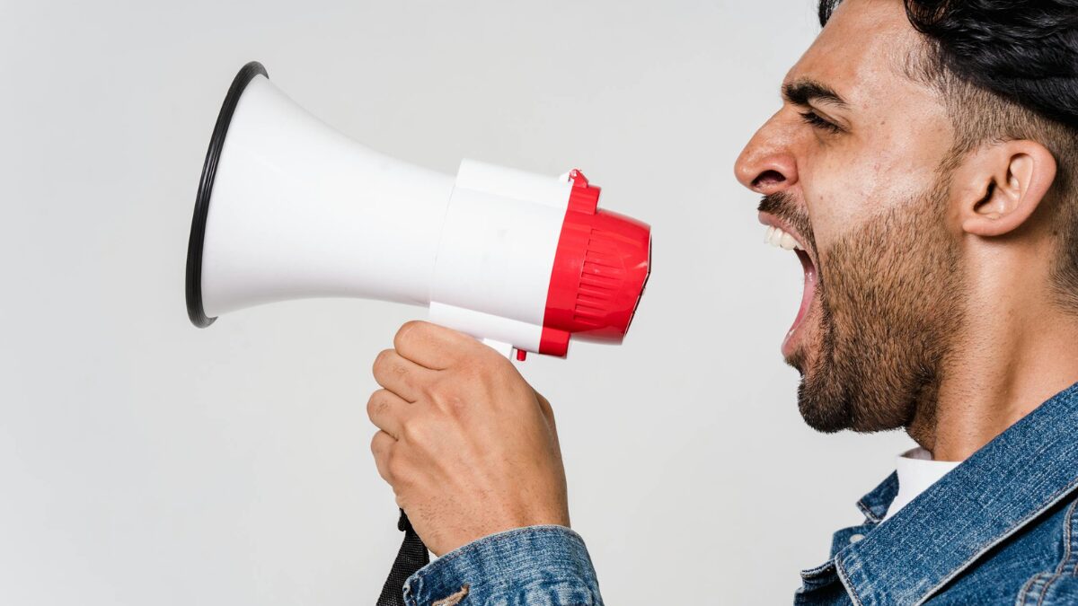 Stock photo of a person talking into a megaphone