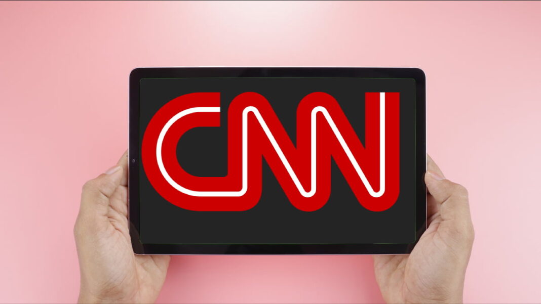 A photo of the CNN logo on a tablet