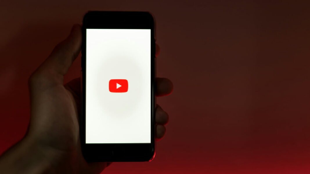 A photo of the YouTube logo displayed on a phone