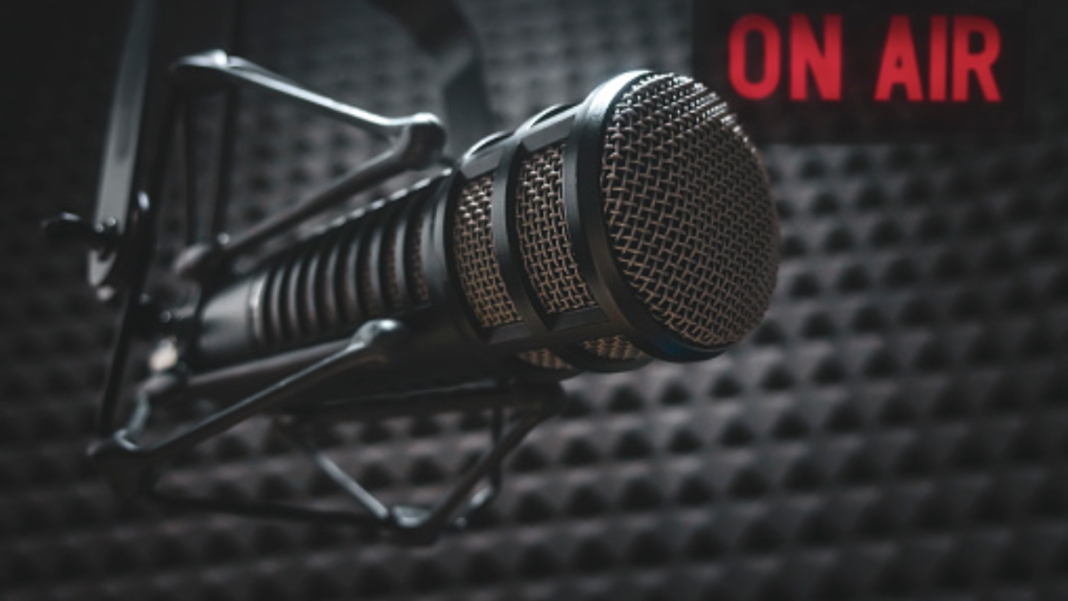 A microphone and an on air light in a radio studio