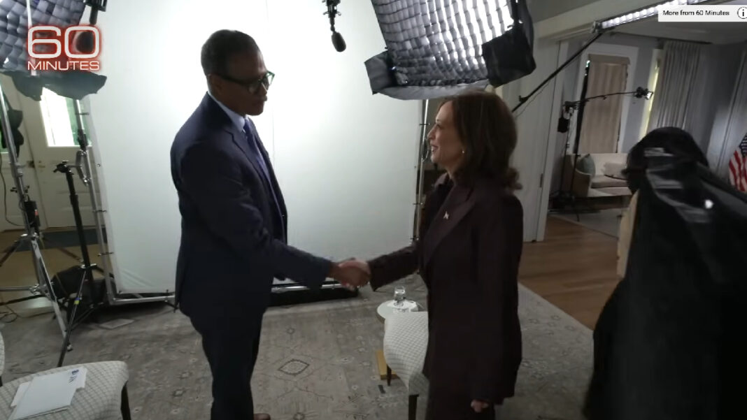 A photo of 60 Minutes correspondent Bill Whitaker shaking hands with Kamala Harris